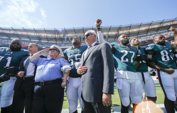 PHOTO: YONG KIM/PHILADELPHIA INQUIRER Eagles owner Jeffrey Lurie stands with Eagles defensive end Brandon Graham and strong safety Malcolm Jenkins during the national anthem before Sunday’s game. September 24, 2017