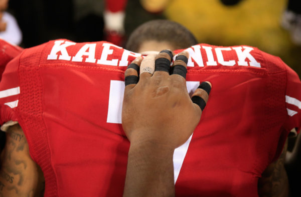 Kaepernick prayed with members of the Ravens after a preseason game in Baltimore in 2014. ROB CARR / GETTY IMAGES