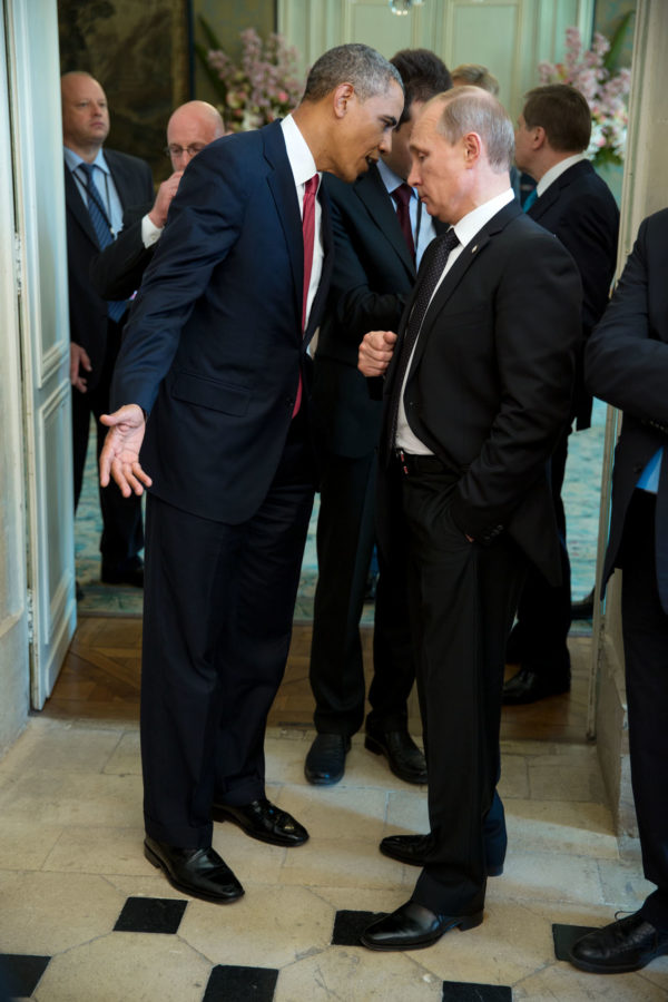 President Barack Obama talks with President Vladimir Putin, President of the Russian Federation, after a lunch with other foreign leaders to commemorate the 70th anniversary of D-Day, at Château de Bénouville in Normandy, France, June 6, 2014. (Official White House Photo by Pete Souza)