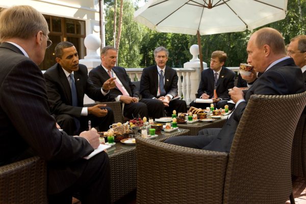 President Obama and Russian Prime Minister Vladimir Putin, center right, converse on a terrace at Putin's residence outside Moscow on July 7, 2009. (Official White House Photo by Pete Souza)