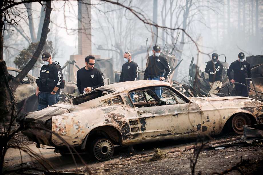 Police officers search for signs of Karen Aycock, a Coffey Park resident who has been missing since the Tubbs fire roared through her neighborhood, in Santa Rosa, Calif., on Tuesday, Oct. 10, 2017. Noah Berger, Special to The Chronicle