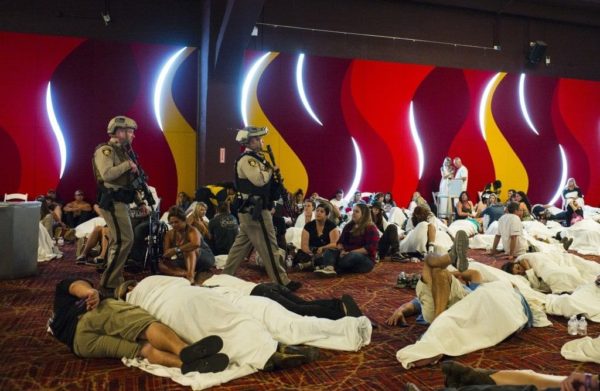 Chase Stevens / Las Vegas Review-Journal via AP Caption: Las Vegas police sweep through a convention center area during a lockdown on Oct. 2, 2017, at the Tropicana Las Vegas following an active shooter situation on the Las Vegas Strip.  