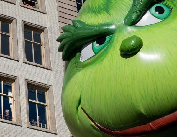Photo: Craig Ruttle/AP Caption: The Grinch balloon passes by windows of a building on Central Park West during Macy's Thanksgiving Day Parade in New York Thursday, November 23, 2017.