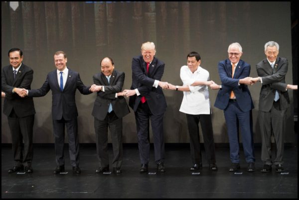 Photo:Doug Mills/New York Times Caption: Donald Trump joins other leaders in a handshake with President Rodrigo Roa Duterte, right, during the opening ceremony of the 31st ASEAN Summit. November 12, 2017 