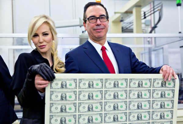 Steven Mnuchin, U.S. Treasury secretary, right, and his wife Louise Linton hold a 2017 50 subject uncut sheet of $1 dollar notes bearing Mnuchin's name for a photograph at the U.S. Bureau of Engraving and Printing in Washington, D.C., U.S., on Wednesday, Nov. 15, 2017. A change in the Senate tax-overhaul plan that would expand a temporary income-tax break for partnerships, limited liability companies and other so-called "pass-through" businesses won the endorsement of a national small-business group today. Photographer: Andrew Harrer/Bloomberg via Getty Images