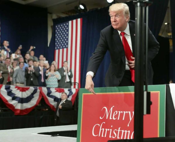 Photo: Andrew Harnik, AP. President Donald Trump points to sign that reads Merry Christmas as he arrives to speak about tax reform at the St. Charles Convention Center, Wednesday, Nov. 29, 2017, in St. Charles, Mo.