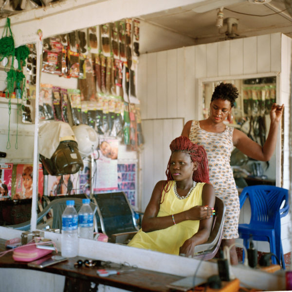  Nadia Tushabe, the owner of Galaxy salon in Juba, styles Hariet Aroma’s Hair.” Sarah Hylton for the New York Times