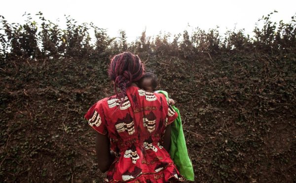 Annie, 29, holds her 2-month-old son, who she says was fathered by a soldier from Gabon. Photo: Jane Hahn/ Washington Post