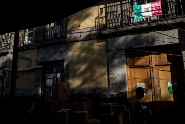 Photo: Adriana Zehbrauskas / New York Times Caption: The house, with its large wooden doors, is hidden behind a maze of street vendors in a Mexico City neighborhood.