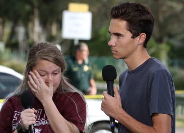 Photo: Mark Wilson/Getty Images. Marjory Stoneman Douglas High School students Kelsey Friend and David Hogg speak to reporters on Thursday, the day after a gunman killed seventeen people at their school.
