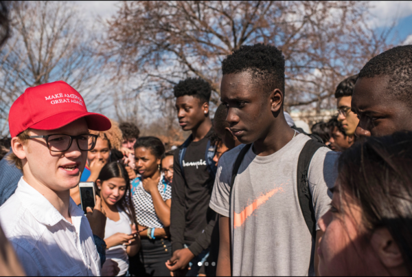 Ben Oppold, 20, of Duluth, Minn., engages with local teenagers rallying for gun safety law reform in wake of the Parkland Florida shooting on February 21, 2018. Oppold is in town for CPAC and was at the Capitol for a tour with his friend Trevor Tovsen also from Duluth, Minn. John Shinkle/POLITICO