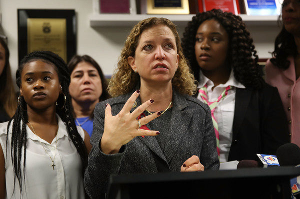 Photo: Joe Raedle/Getty Images Caption: Rep. Debbie Wasserman Schultz (D-FL) speaks to the media as Megan Hobson (L), who survived after being shot with an AK-47 when she was 16 years old, and Marjory Stoneman Douglas High School mass shooting survivor Mei-Ling Ho-Shing,17, (R) stand behind her after a gun safety roundtable discussion on March 5, 2018 in Sunrise, Florida