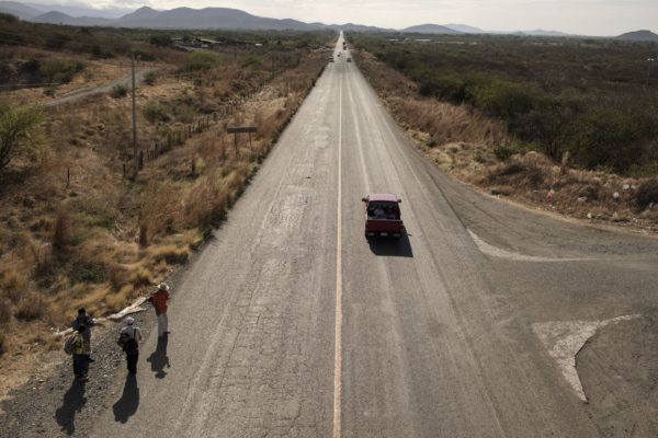 Central American asylum-seekers walk along a road in Santiago Niltepec. Photographer: Jordi Ruiz Cirera/Bloomberg