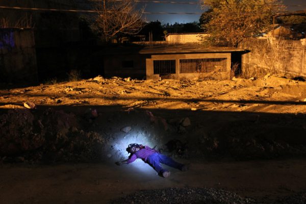 Photos: John Moore / Getty Images A man killed in a suspected drug-related execution in 2012 in Acapulco, Mexico. Violence has surged in Acapulco, once Mexico’s top tourist destination, spurring the flight of many Mexicans