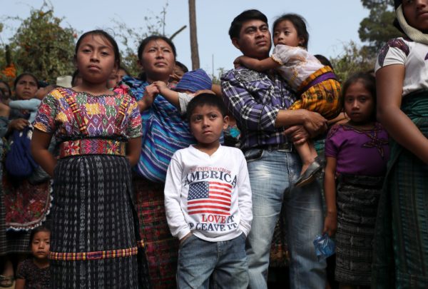 Photos: John Moore / Getty Images Caption: Families at a memorial service for two boys who were kidnapped and killed in February 2017 in San Juan Sacatepéquez, Guatemala