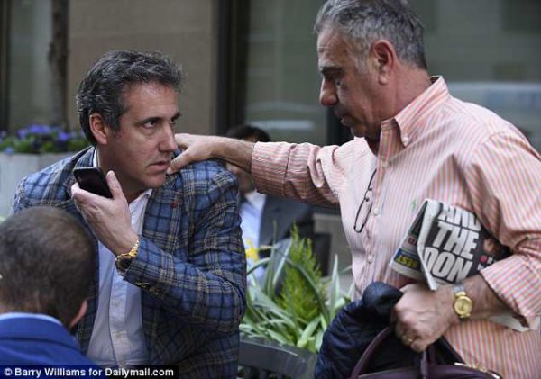 Photo: Barry Williams/Daily Mail Caption: Awkward? One of Cohen's pals was carrying a copy of the New York Post, which featured a front page story about the lawyer's client Donald Trump, and former FBI Director James Comey
