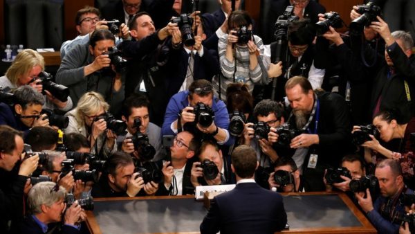 Photo: Leah Millis/Reuters Caption: Mark Zuckerberg is surrounded by members of the media as he arrives to testify. April 9, 2018