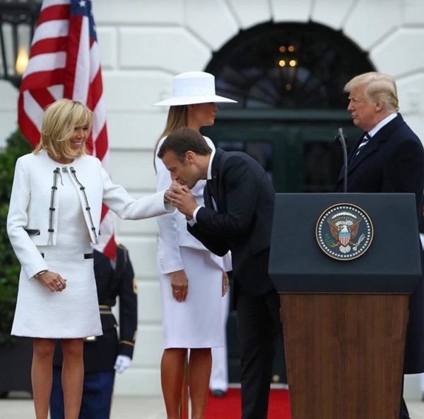 Photo: Mark Wilson/Getty Images Caption: French President Emmanuel Macron kisses the hand of his wife, French first lady Brigitte Macron, as they are welcomed by U.S President Donald Trump and U.S. first lady Melania Trump during a state visit arrival ceremony at the White House April 24, 2018 in Washington, DC. Trump is hosting Macron for a two-day official state visit that includes dinner at George Washington's Mount Vernon, a tree planting on the White House South Lawn and a joint news conference.