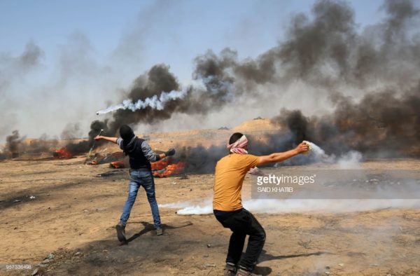 A demonstrator uses a racket to return a tear gas canister fired by Israeli troops during clashes along the border with the Gaza strip east of Khan Yunis on May 11, 2018, as Palestinians demonstrate for the right to return to their historic homeland in what is now Israel. - Over fifty Palestinians have been killed by Israeli fire since protests and clashes began on March 30 calling for Palestinian refugees to be able to return to their former homes in what is now Israel. Said Khatib/Getty