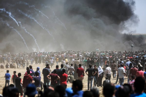 Palestinian protesters gathered near the fence between Gaza and Israel on Monday as clashes with Israeli soldiers intensified.CreditHosam Salem for The New York Times