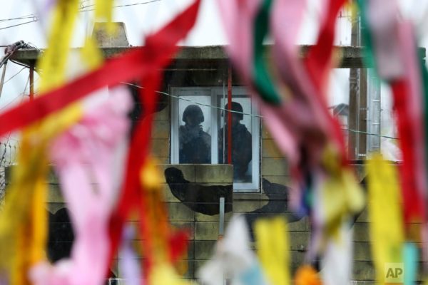 In this Wednesday, May 16, 2018, file photo, South Korean army soldiers stand guard inside a military guard post as ribbons hanging on a wire fence wishing for the reunification of the two Koreas at the Imjingak Pavilion in Paju near the border village of Panmunjom, South Korea. North Korea on Wednesday canceled a high-level meeting with South Korea and threatened to scrap a historic summit next month between U.S. President Donald Trump and North Korean leader Kim Jong Un over military exercises between Seoul and Washington that Pyongyang has long claimed are invasion rehearsals. (AP Photo/Ahn Young-joon, File)