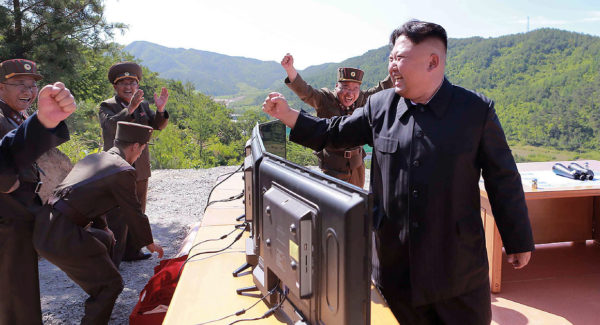 Photo 1: North Korean chief Kim Jong Un reacting after the test-fire of the intercontinental ballistic missile Hwasong-14 at an undisclosed location, November 2017, STR/AFP/Getty