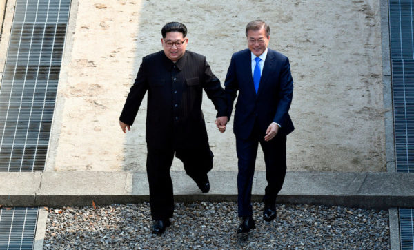 Kim Jong Un, left, and South Korean President Moon Jae-in cross the military demarcation line at the border village of Panmunjom in Demilitarized Zone Friday, April 27, 2018, AP