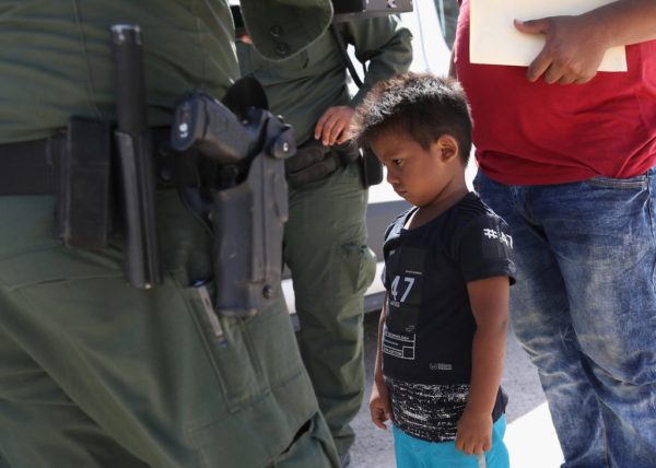 MISSION, TX - JUNE 12: U.S. Border Patrol agents take a father and son from Honduras into custody near the U.S.-Mexico border on June 12, 2018 near Mission, Texas. The asylum seekers were then sent to a U.S. Customs and Border Protection (CBP) processing center for possible separation. U.S. border authorities are executing the Trump administration's zero tolerance policy towards undocumented immigrants. U.S. Attorney General Jeff Sessions also said that domestic and gang violence in immigrants' country of origin would no longer qualify them for political-asylum status. (Photo by John Moore/Getty Images)