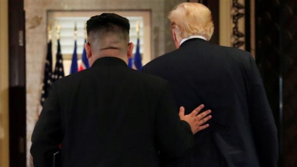 President Trump and Kim Jong Un leave after signing documents at Singapore summit, Tuesday June 12, Reuters/Jonathan Ernst