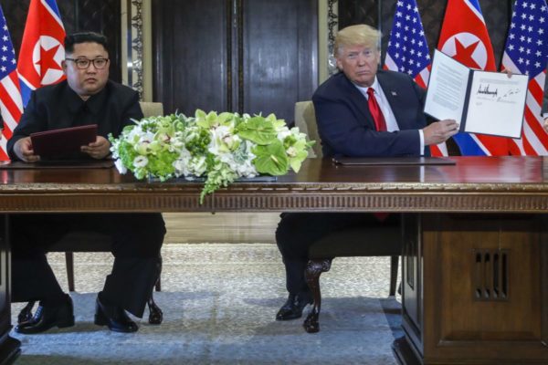 President Donald Trump holds up the document that he and North Korean leader Kim Jong Un just signed at the Capella resort on Singapore’s Sentosa island Tuesday, June 12 2018, AP Photo/Evan Vucci