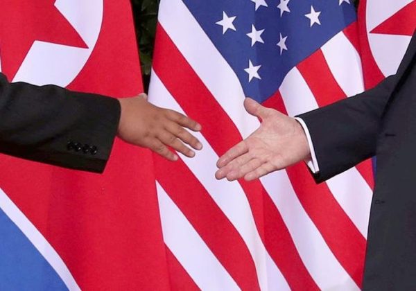 Photo: Jonathan Ernst/Reuters Caption: Donald Trump, right, reaches to shake hands with the North Korea leader, Kim Jong-un, on Sentosa Island in Singapore.