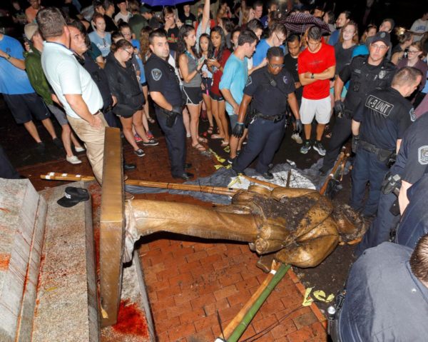 Police and protesters surround the toppled statue of a Confederate soldier nicknamed Silent Sam on the University of North Carolina campus after a demonstration for its removal in Chapel Hill, North Carolina, U.S. August 20, 2018. REUTERS/Jonathan Drake