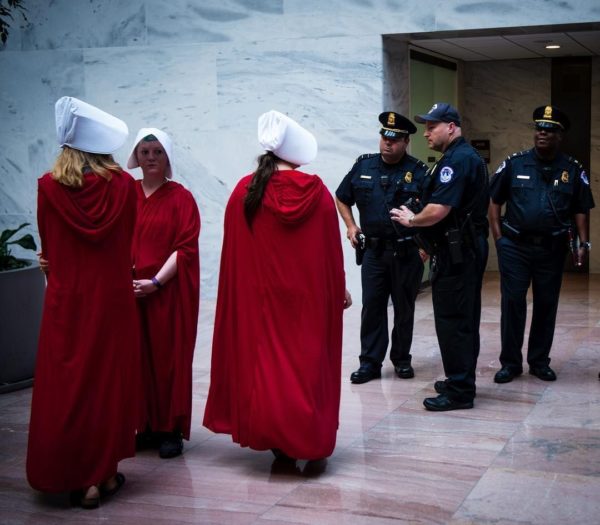 Handmaids and police congregate outside of the Kavanaugh hearing on Day One. September 5, 2018