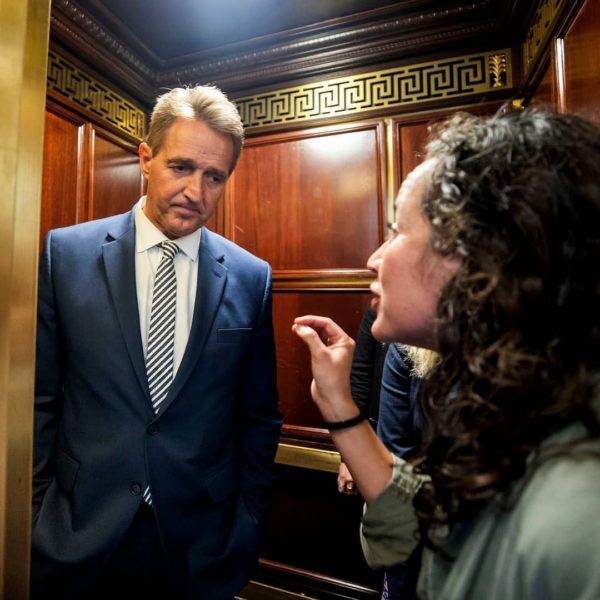 A woman who says she is a survivor of a sexual assault confronts Sen. Jeff Flake (R-Ariz.) in an elevator on Friday, Sept. 28, after Flake announced that he would vote in favor of sending Kavanaugh's nomination to the wider Senate for debate. 