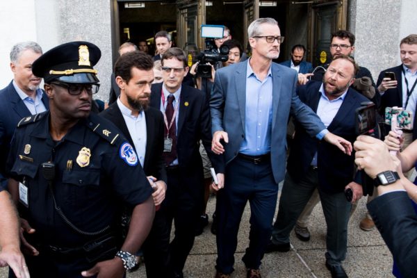 Photo: M. Scott Mahaskey/POLITICO . Caption: InfoWars’ Alex Jones yells at Twitter CEO Jack Dorsey as he left the Senate hearing on foreign electioneering on social media. Jones, known for spreading baseless conspiracy theories, alleges that tech companies are biased against conservatives