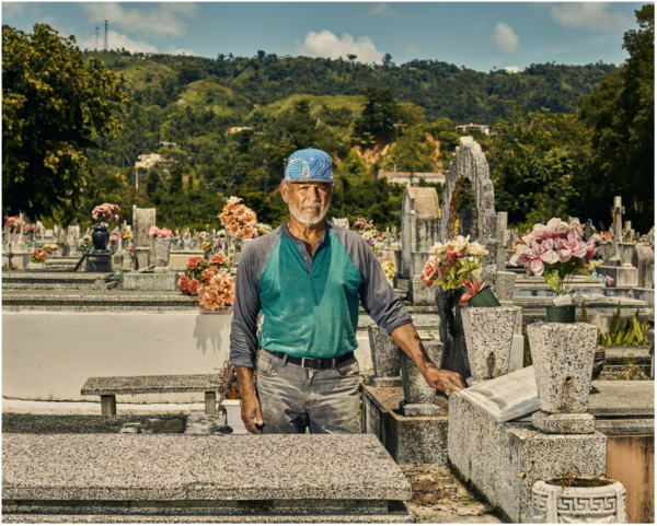 Christopher Gregory / TIME. Gravekeeper Tulio Collazo Vega poses by the grave of three elderly sisters who were killed by a landslide the day Maria hit Puerto Rico.