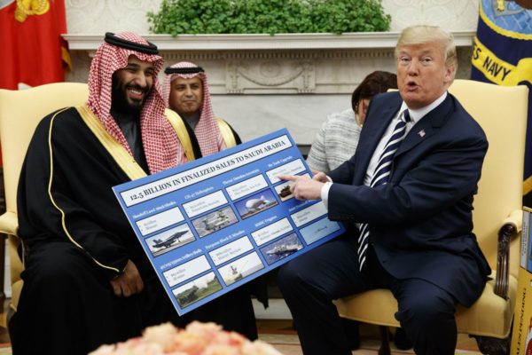 President Donald Trump shows a chart highlighting arms sales to Saudi Arabia during a meeting with Saudi Crown Prince Mohammed bin Salman in the Oval Office of the White House, March 20, 2018, in Washington. Evan Vucci/AP