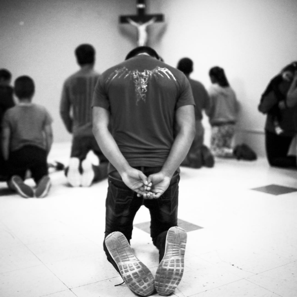 Photo: Mario Tama/ Getty Images Caption: Migrants pray at an Annunciation House shelter for migrants on October 13, 2018 in El Paso, Texas. Annunciation House said it is currently receiving over 700 migrants released from ICE holding cells after crossing the border per week. Most migrants say they are fleeing desperate conditions in their home countries.