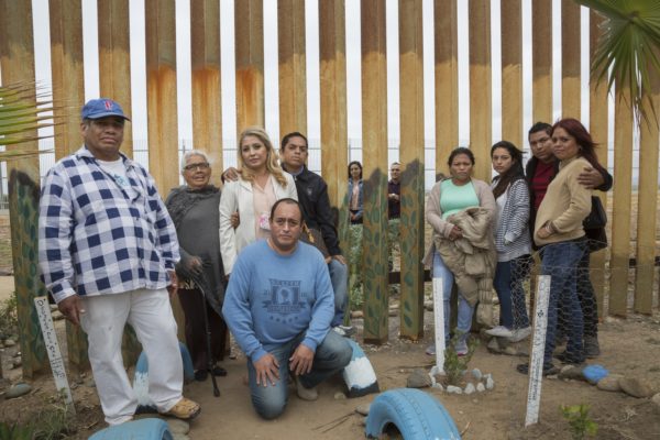 Photo: Griselda San Martin Caption: The Salgado family poses for a portrait. Cesar Salgado and his niece Giselle are on the American side of the fence. Cesar’s parents, siblings, and daughter (third from right) are on the Mexican side. This is the first time Cesar has seen his daughter in 14 years.