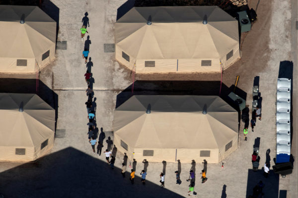 Photo: Mike Blake/Reuters Caption: Immigrant children, suspected of illegal border crossings, are led by staff in single file between tents at a detention facility next to the Mexican border in Tornillo, Texas, June 18, 2018. It was not immediately clear whether these "unaccompanied minors" were apprehended without adults or separated from parents under a "zero tolerance" policy by the Trump administration. REUTERS/Mike Blake. NYT caption: Migrant children at a detention facility in Tornillo, Tex.