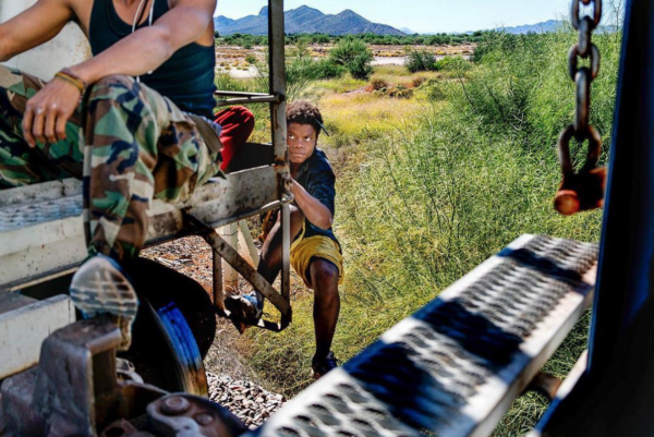 Photo: Nick Oza/ Gannett Caption: A Honduran migrant jumps aboard a moving freight train in Mexico headed toward the U.S. border south of Caborca, Sonora. There are many cases of migrants who have lost legs after falling off the freight trains known as La Bestia, The Beast. This photo was taken in late October 2018.