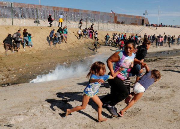 Photo: Kim Kyung-Hoon/Reuters Caption: Maria Lila Meza Castro, center, a 39-year-old migrant woman from Honduras, runs away from tear gas with her 5-year-old twin daughters Saira Nalleli Mejia Meza, left, and Cheili Nalleli Mejia Meza at the border wall between the U.S. and Mexico, in Tijuana on Nov. 25, 2018.