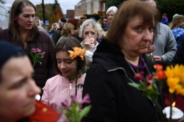 Photo: BRENDAN SMIALOWSKI/AFP/Getty Images People arrive to pay their respects in front of a memorial on October 28, 2018 outside of the Tree of Life synagogue after a shooting there left 11 people dead in the Squirrel Hill neighborhood of Pittsburgh on October 27, 2018.