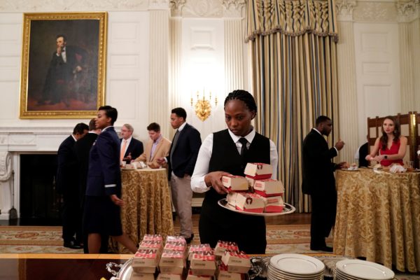 Photo: Joshua Roberts/Reuters Caption: A server places hamburgers in the State Dining Room of the White House.