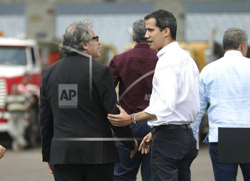 Venezuela's self-proclaimed interim president Juan Guaido, right, speaks with OAS Secretary General Luis Almagro, outside the warehouse housing U.S. humanitarian aid destined for Venezuela, in Cucuta, Colombia, Saturday, Feb. 23, 2019. (AP Photo/Fernando Vergara)