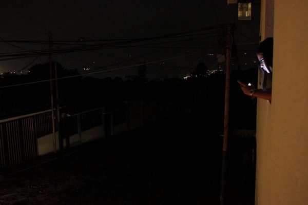 Photo: Carlos Eduardo Ramirez/Reuters Caption: A girl uses her cell phone at the window of her house during a blackout in San Cristobal, Venezuela March 14, 2018. But because of the economic crisis, Venezuela has reduced electricity consumption to about 14,000 megawatts at peak hours, according to engineer and former electricity executive Miguel Lara. Two years ago, state-run Corpoelec put the figure at 16,000 megawatts.