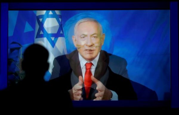 Photo: Kevin Lamarque/REUTERS Caption: A monitor transitions from a still image to a video satellite feed from Israel of Israeli Prime Minister Benjamin Netanyahu addressing AIPAC in Washington.
