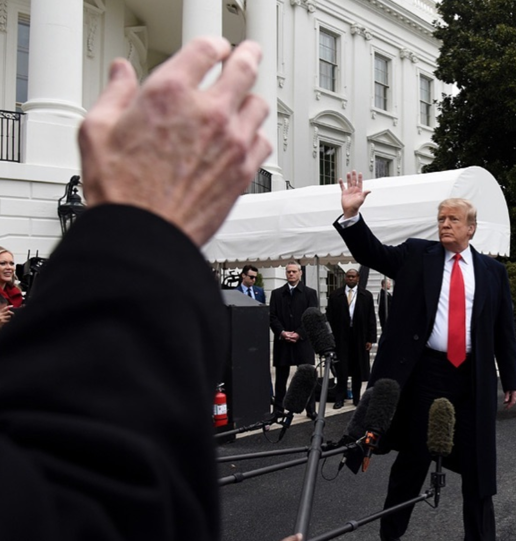 US President Donald Trump waves as a reporter tries to ask a question while departing the White House on Friday, March 22, 2019. Photo by Olivier Douliery 