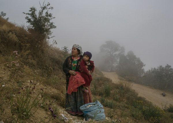 Photo 1: Mauricio Lima. Caption: Outside the small village of Chicua, in the western highlands, in an area affected by extreme-weather events, Ilda Gonzales looks after her daughter.