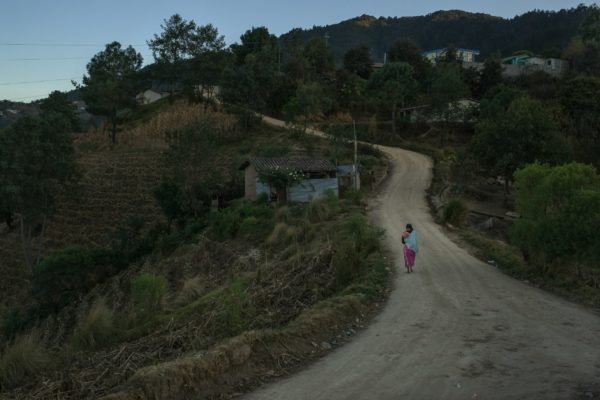 Photo 5: Mauricio Lima. Caption: In Paraje León, a mother walks home with her baby at dusk. This remote corner of the highlands department of Totonicapán is on the edge of an expanding swath of Central America’s dry corridor.